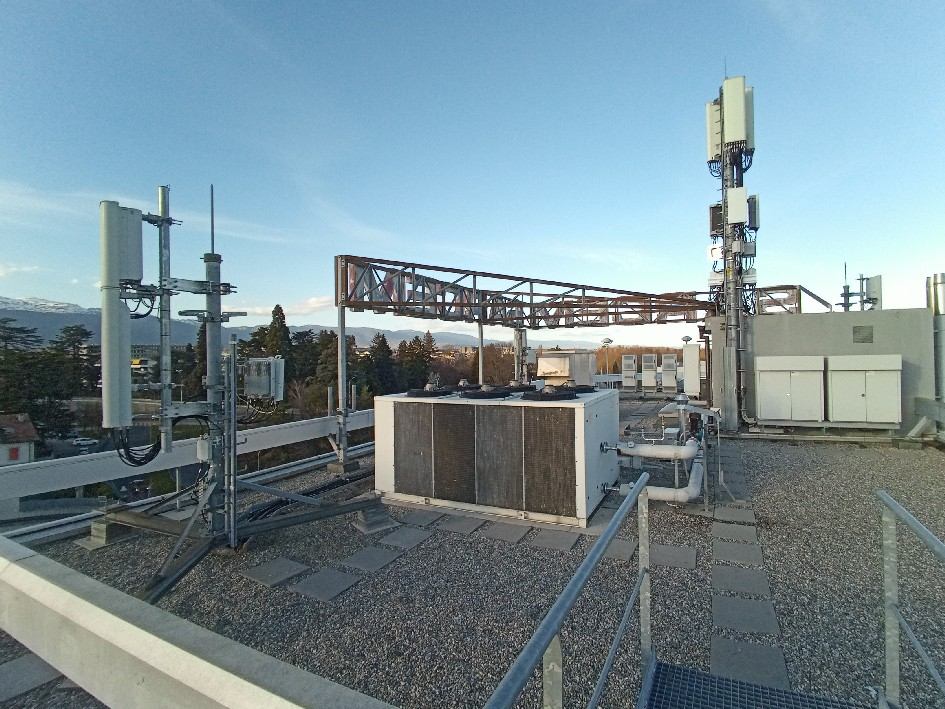 Telecommunication antennas and equipment installed on a rooftop.