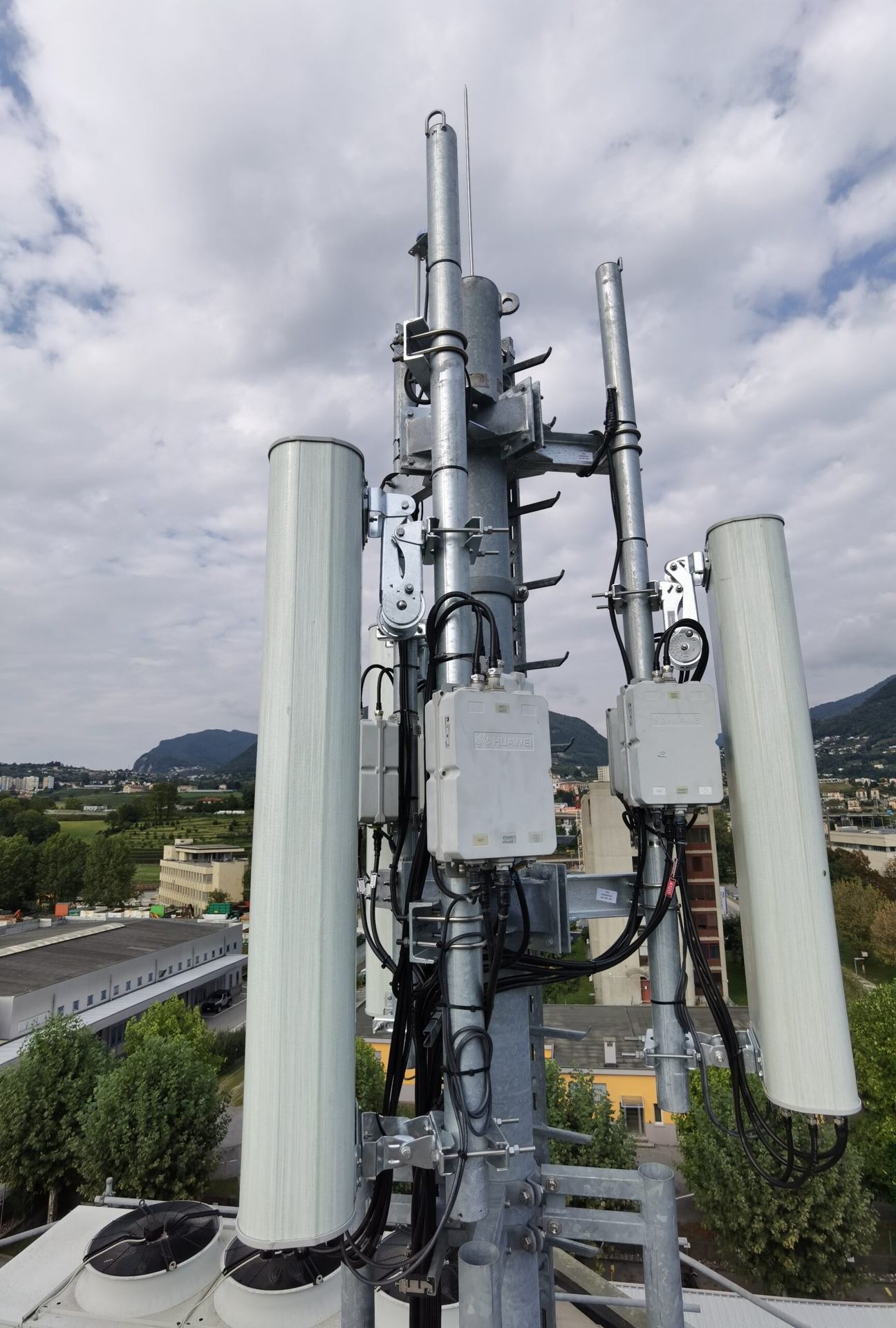 Panel antennas and equipment mounted on a mast.