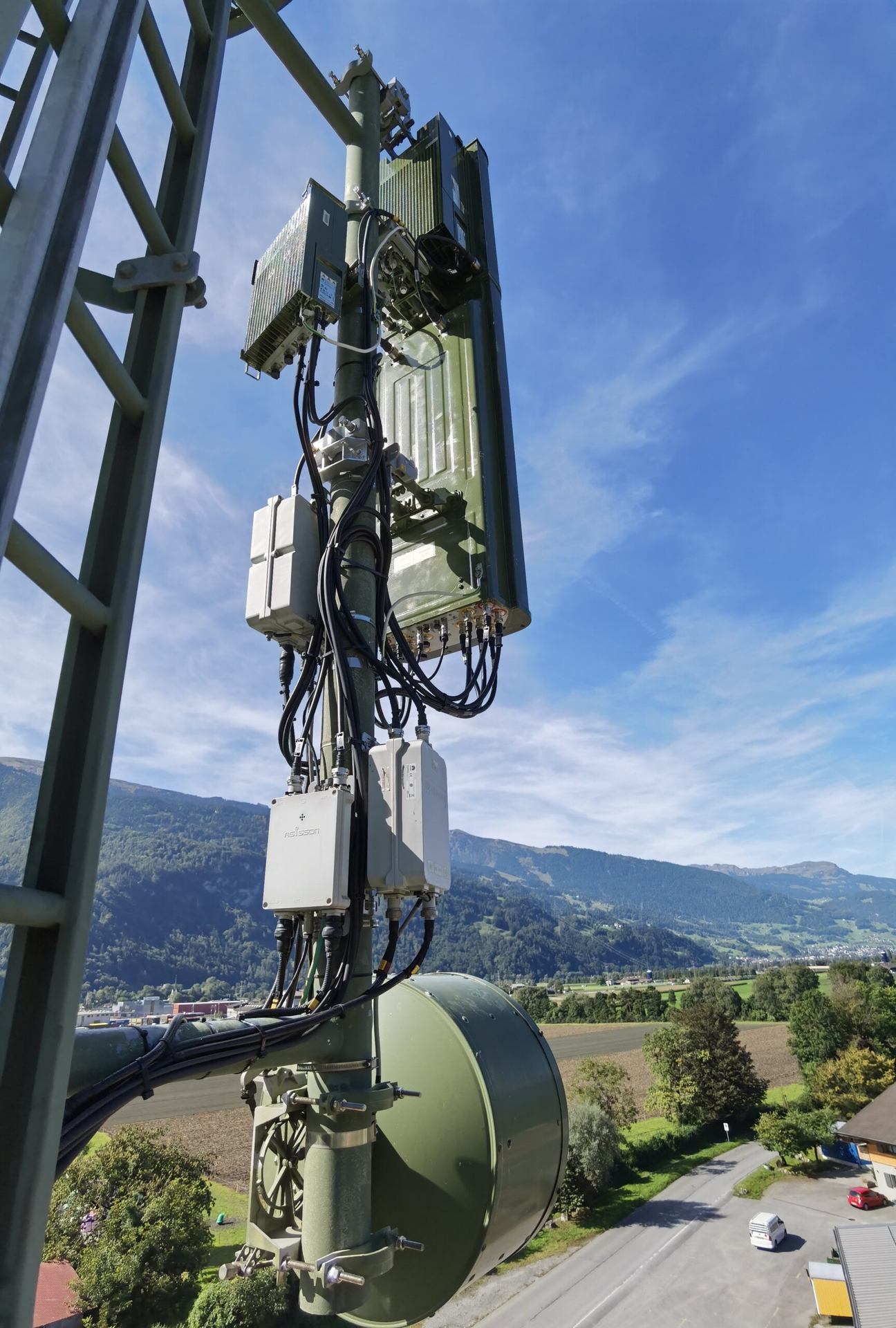 Panel and dish antennas attached to a steel tower.