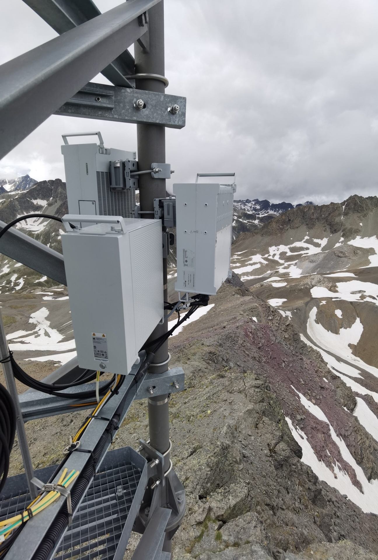 Telecommunications equipment and brackets high on a mast.