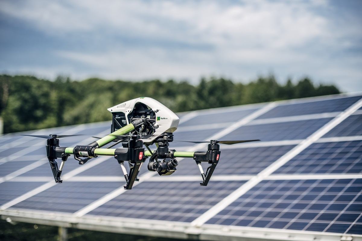 A drone in front of photovoltaic modules.